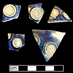 Gray-bodied salt glazed stoneware hollow vessel fragments showing different prunt motifs. Applied prunts outlined with cobalt-blue under the glaze. Similarly decorated vessels in printed sources dated c. 1680 from 18CV60.