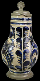 Gray-bodied salt glaze stoneware hollow (mug or jug) with engraved (incised) foliage outlined in cobalt-blue painted under the glaze. Lot number: 18CV60-1.429., Complete vessels with similar motifs have been dated circa 1720. Vessel shown is from http://martynedgell.com/index.php/product/westerwald-saltglaze-stoneware-jug-circa-1720/.