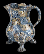 Lead-glazed agateware cream jug, Staffordshire, ca. 1750.  H. 10". The body of this jug was formed in a two piece press mold.  (Chipstone Foundation.) 