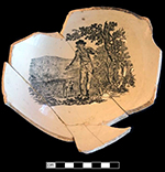 Overglaze printed creamware chamberpot.  Scratches through the printed motif are visible on the interior base of the vessel. Rim diameter:  8.0”; Base diameter:  4.75” - from 18BC33.