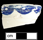 Overglaze painted scalloped border motif in blue. Probable tureen lid from HanleySite-Staffordshire England.