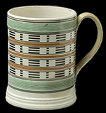 Engine turned creamware mug with green rouletted bands- c. 1800 from a Private collection.