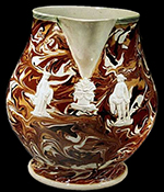 Creamware pitcher with sprig molded designs on a marbleized variegated surface - Private collection.