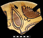North Midlands slip decorated dish with trailed and “jeweled” slip crossed leaf (?) and butterfly/moth (?) motifs, Coggled rim, Rim diameter: 12.00”, from 18AN39. 