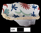 Coffee or teapot lid decorated in floral motif in blue, red and green - This style characterized by rich colors on an almost dead white background (Britton 1982:209). Pieces illustrated in Britton date between c. 1705 (p. 86) and the 1720s and 1730s.