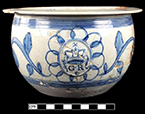 Pearlware scratch blue chamberpot with GR sprig molded medallion. Rim diameter:  8.12”, Base diameter: 4.50”, Vessel height: 4.50”. Lot: 9, Provenience:1G3.886.106, Privy Stratum 2 - 18BC38