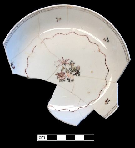 Chinese porcelain saucer, painted overglaze in famille rose palette with floral and neoclassical rim band. Neoclassical rim bands were most common on Chinese export porcelain between c. 1765 and 1810 (Madsen and White 2011). Rim diameter: 5.50”. Lot: 47F 346-78. 18BC50