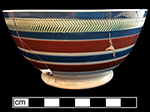Pearlware common shape bowl banded in blue, white and reddish brown.  Green herringbone rouletting along rim. 6.0� rim diameter, 3.125� vessel height.