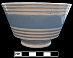 Refined white earthenware London shape bowl banded in blue and pale grey.  Color combination more typical of the mid-19th century production. Rim diameter:  5.00”; Base diameter:  2.25”; Vessel height: 3.00” from 18QU124.