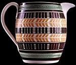 Pearlware barrel form jug. Pattern cut through slip bands with two different knives between bands of green glazed herringbone and beads rouletting, c. 1820. 6.5 inches in height - from a private collection.