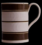 Pint mug. "Blind" engine-turning using a curved blade with crown cam and no slip inlay. 5 inches in height.