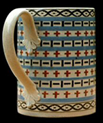 Pint mug. Impressed mark Wood & Caldwell. Inlays in two colors, A 1797 invoice of this firm includes the terms Brick, Chainband, Bastile, Mocoa, and Fr. Fray, plain. I believe the first three to be engine-turned or rouletted pattern names. The rouletted pattern on this mug may be the chain band referenced. 5 inches in height - from a private collection.
