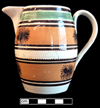 Creamware dipt jug with dendritic motif. Rim diameter:  3.00”, Base diameter:  2.75”, Vessel height: 5.00”. Lot: 9, Provenience:1G3.674.1, Privy Stratum 2
 - 18BC38