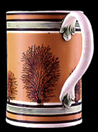 Creamware pint mug, dipped and banded, with mocha decoration and green-glazed reeding or rilling, c. 1800. 5 inches in height - from a private collection.