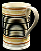 Creamware pint mug with inlaid slip banding, Reeded or rilled bands & highlighted with glaze to which antimony or uranium oxide has been added to create yellow color, c. 1820. 5 inches in height - Private collection. 