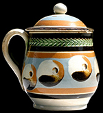 Mustard pot decorated with cat's eyes and green- glazed herringbone rouletting, 4 inches in height - from a private collection.
