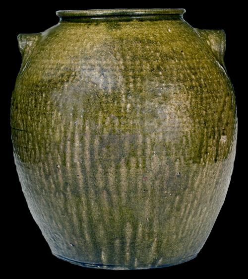 Ten-Gallon Alkaline-Glazed Stoneware Jar, Possibly Daniel Seagle, Lincoln County, NC origin, circa 1840, large-sized, rotund jar with thin, semi-rounded rim, and curved lug handles, the surface covered in a mottled green alkaline glaze with heavier glaze runs at the handle terminals - from a private collection.