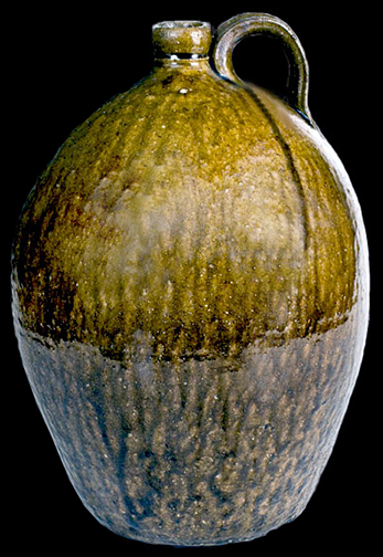 Three-Gallon Alkaline-Glazed Stoneware Jug, Stamped "JFS", James Franklin Seagle,Vale, Lincoln County, NC, third quarter 19th century, highly-ovoid jug with tooled spout, the surface covered in a streaky, olive-green alkaline glaze - from a private collection.