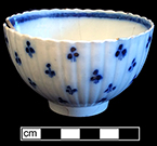 Chinese or common shape pearlware cup underglaze painted with floral sprigged pattern.  Scalloped rim and fluted body.3.5” rim diameter and 2.25” height. Lot 190-7. 18BC66