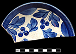 Pearlware painted underglaze saucer with floral  and berry motif.  6” rim diameter; 1.25” vessel height.