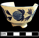 Pearlware painted underglaze London shape cup with strawberry motif. Two matching cups found in this privy assemblage. 3.75” rim diameter; 2.5” vessel height.