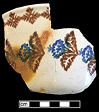 Cut sponge bowl  with brown and blue floral motif. Rim diameter:  6.50”.
