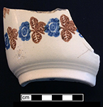 Cut sponge bowl  with brown and blue floral motif.  A copy of Belleek’s Snowflake pattern. Base diameter:  3.00”