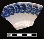 Cut sponge saucer with blue floral motif. Rim diameter:  6.50”.