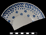 Cut sponge decorated saucer with geometric pattern of zigzags, chevrons, dots and stars.