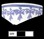 Cut sponge decorated cup in cross-shape motif.