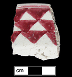 Cut sponge decorated plate with bands of triangles in chrome red.