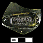 Mineral water bottle seal with text WILDUNG WASSER.  Text stamped from a rectangular plate pressed into molten seal glass; 50 x 20 mm from 18BC27.