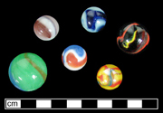Private collection - Machine made glass marbles.  Patched marble.  Late 1920s-mid-1950s, two patches of different colors, generally on an opaque white body (Randall and Webb 1988:43) - click image to see larger view.