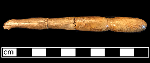 Bone handled toothbrush with turned handle. Flat cranking with probable wire drawn bristle attachement. Stick shaped handle with rounded cross section. 1G2.648; 1G2.426.58 - 18BC38