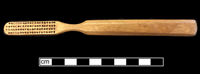 Bone handled toothbrush with gradual/abrupt neck.Trepanned brushes. Handle has hexagonal cross section; rounded base. 18BC66