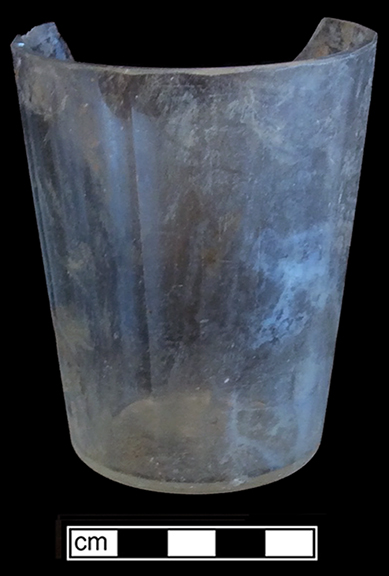 Colorless soda lime glass tumbler with molded flat panels.  Empontilled. Rim diameter: 3.00”; Base diameter: 2.25”; Vessel height: 3.60”. Lot 190-56. 18BC66.
