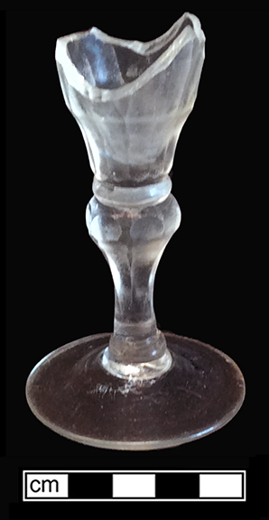 Colorless leaded stemmed glass with conical bowl, plain stem and folded foot. Empontilled. Rim diameter: 2.50”; Foot diameter: 2.50”; Vessel height:  4.50”. Lot 186-64B. 18BC66
