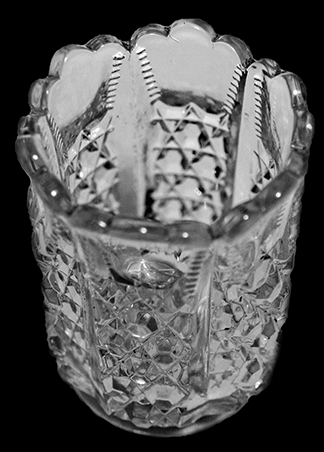Colorless glass berry bowl. Similar to design on toothpick holder on right described as "EAPG - G. Duncan-Button Panel-Toothpick holder with straight sides" from a private collection. 18CV13