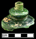 Green glass lamp glass or perfume bottle with gold painted motif and ground lip. Rim diameter: 5/16”. 18BC27