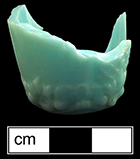 Hollow vessel (possible shot glass or toothpick holder?) of opaque green glass. Base diameter: 1 1/8”. 18BC27