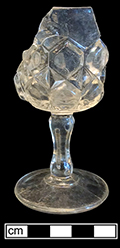 Colorless soda lime cordial stemmed glass with molded button pattern. Base shows three mold lines. Rim diameter:  2.00”, Base diameter:  2.00”, Vessel height: 4.00”. Lot: 100. 18BC80