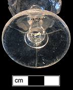 Colorless soda lime cordial stemmed glass with molded button pattern. Base shows three mold lines. Rim diameter:  2.00”, Base diameter:  2.00”, Vessel height: 4.00”. Lot: 100. 18BC80