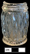 Colorless soda lime glass salt shaker. Screw top, ground finish. Molded diamond motif. Rim diameter: 1.50”, Base diameter:  1.75”, Vessel height: 2.75”. Lot: 101. 18BC80