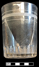 Colorless nonleaded glass tumbler. Fluted/panelled/arched at base.  3.5” tall; 2.75” rim diameter. 18CV13