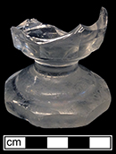 Colorless soda lime glass firing glass? Note very thick base to glass 8-sided base and bowl. 2.75” base diameter (at widest point).  18BC27-F30