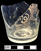 Colorless soda lime glass decanter with  wheel engraving in star or sunburst type motif. 2.5” base diameter. Empontilled with Continental style base finishing discussed in jones at al. 18BC27-F26
