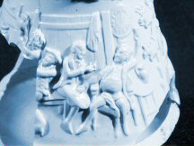 Detail of blue molded jug showing tavern scene.