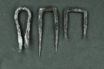 Figure 4 Three iron U-shaped staple with black surface on gray background.