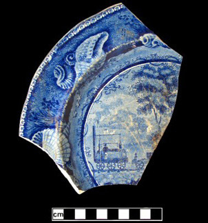 Fragmented blue plate showing railroad scene.
