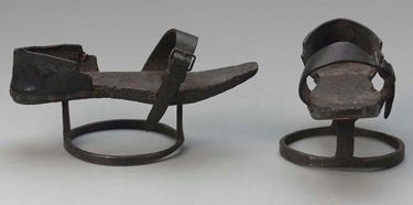 Side and front view of a wooden and iron patten used for elevating user off of the ground.